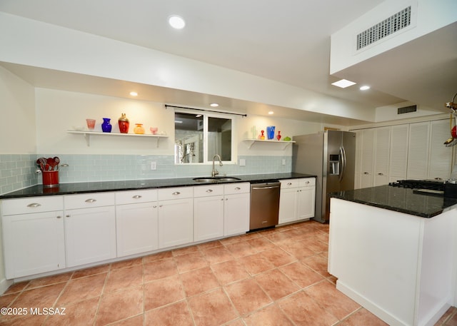 kitchen featuring sink, white cabinets, decorative backsplash, light tile patterned floors, and stainless steel appliances