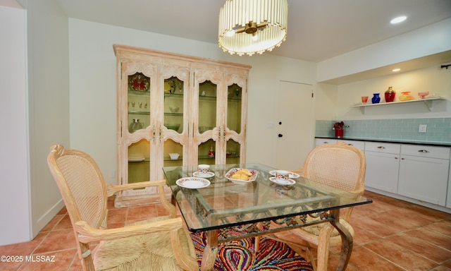 tiled dining area featuring a notable chandelier