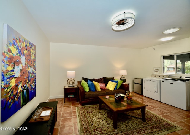 living room with light tile patterned floors and washer and clothes dryer