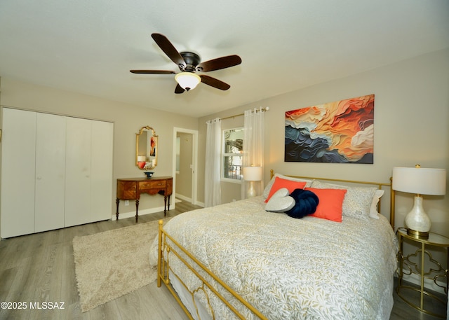 bedroom with a closet, ceiling fan, and light wood-type flooring