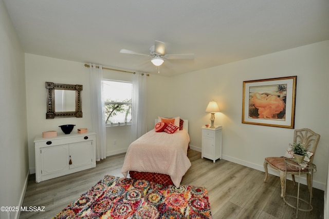 bedroom with ceiling fan and light hardwood / wood-style floors