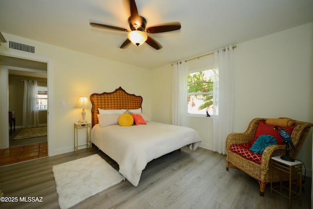 bedroom with ceiling fan and hardwood / wood-style floors