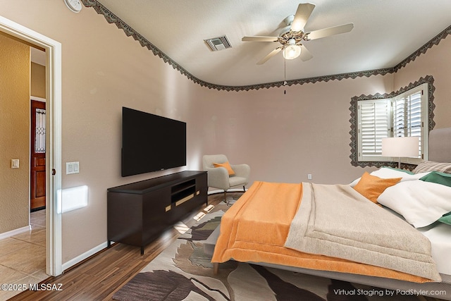 bedroom with hardwood / wood-style floors and ceiling fan