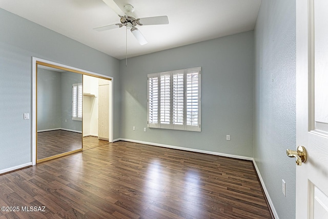 unfurnished bedroom with dark wood-type flooring, a closet, and ceiling fan