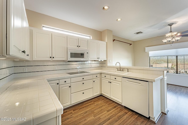 kitchen featuring white cabinetry, tile counters, and white appliances