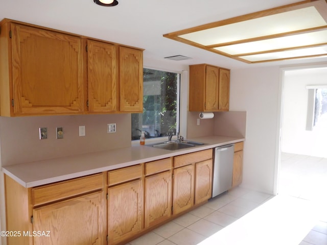 kitchen with a sink, light countertops, dishwasher, and a healthy amount of sunlight