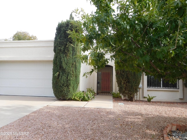 7932 N Casas Cameo, Tucson, AZ 85742 - view of front of property featuring driveway, stucco siding, and an attached garage