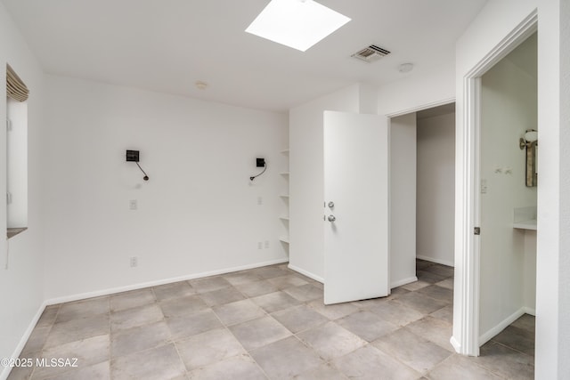 spare room featuring a skylight