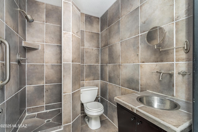 bathroom with tile walls, vanity, toilet, and walk in shower