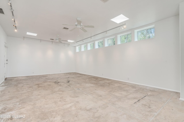 spare room featuring ceiling fan and rail lighting