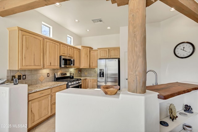 kitchen with tasteful backsplash, appliances with stainless steel finishes, light brown cabinets, and light tile patterned floors