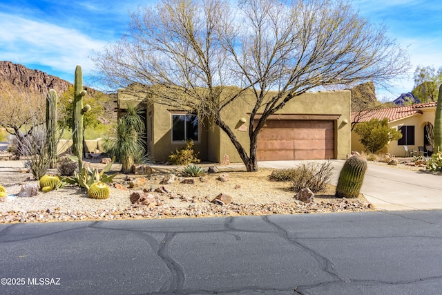 pueblo-style home with a garage