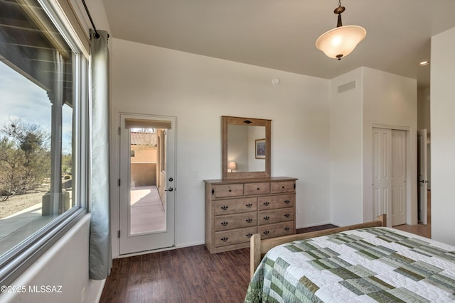 bedroom with dark wood-type flooring and a closet