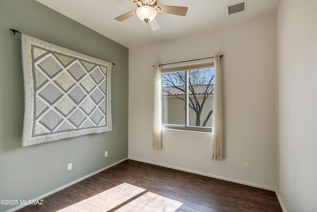 spare room featuring dark hardwood / wood-style floors and ceiling fan