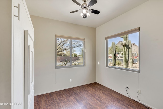 unfurnished room with ceiling fan, plenty of natural light, and dark hardwood / wood-style flooring