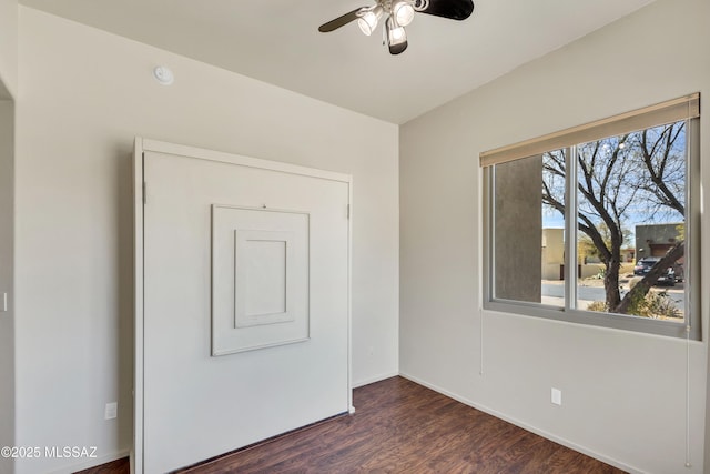 empty room featuring dark hardwood / wood-style floors and ceiling fan