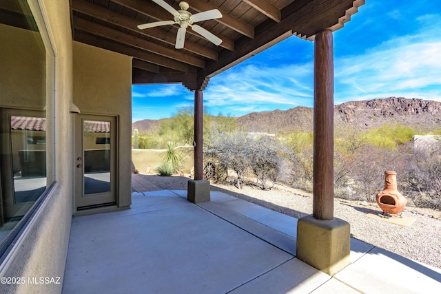 view of patio / terrace featuring a mountain view and ceiling fan