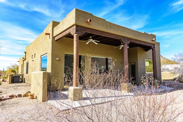 view of property exterior featuring a patio, cooling unit, and ceiling fan