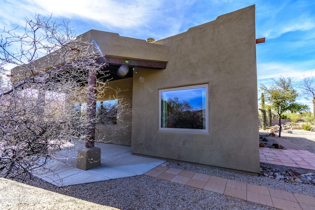 view of property exterior featuring a patio area