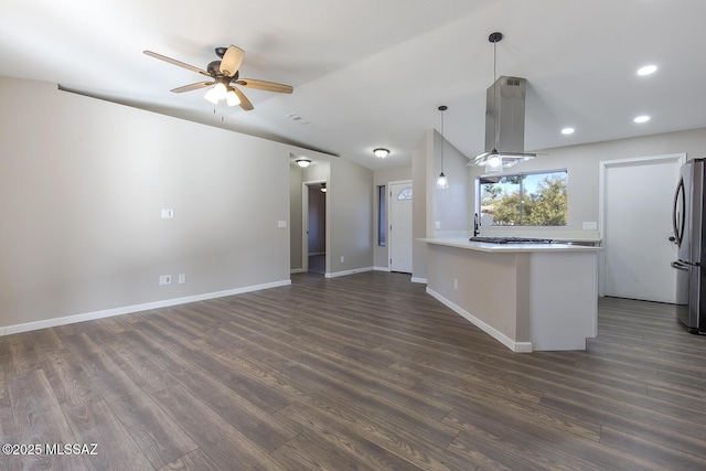 kitchen featuring island exhaust hood, pendant lighting, stainless steel fridge, and dark hardwood / wood-style flooring