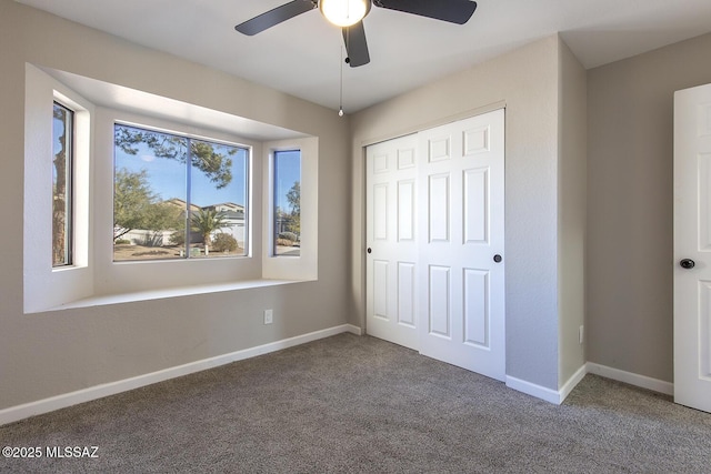 unfurnished bedroom featuring a closet, ceiling fan, and carpet flooring