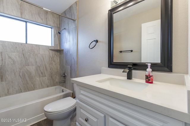 full bathroom featuring vanity, toilet, and tiled shower / bath combo