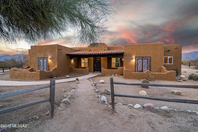 pueblo-style house featuring a mountain view