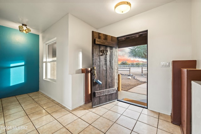 foyer entrance with light tile patterned floors and a wealth of natural light