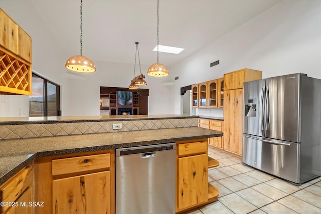 kitchen featuring appliances with stainless steel finishes, pendant lighting, high vaulted ceiling, and light tile patterned floors