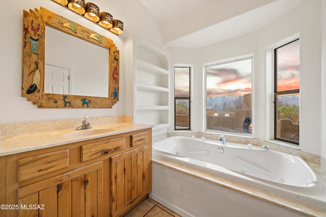 bathroom with vanity, tile patterned floors, a bathtub, and built in shelves