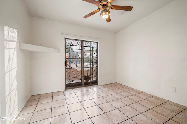 spare room with light tile patterned flooring and ceiling fan