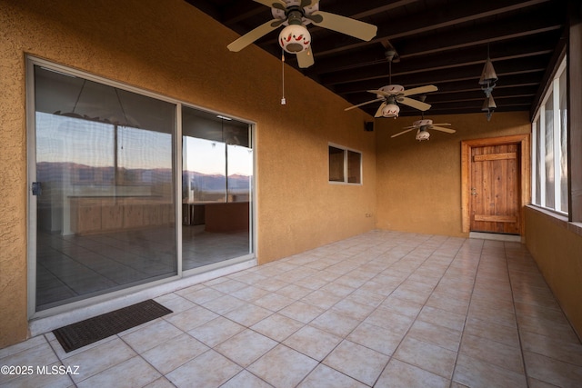 unfurnished sunroom with lofted ceiling with beams