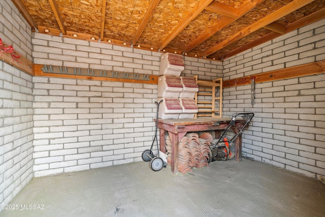 interior space featuring brick wall