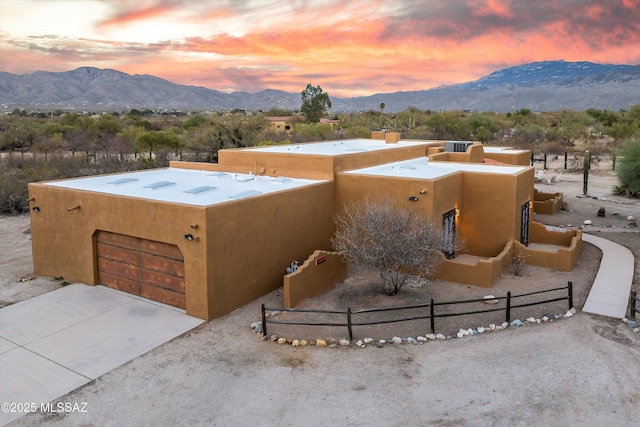 view of front facade with a mountain view and a garage