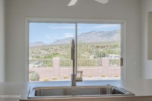 10078 N Bighorn Butte Dr, Tucson, AZ 85737 - kitchen view of a mountain view, a sink, and a ceiling fan