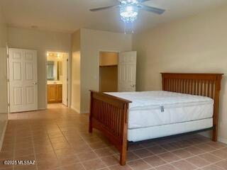 walk in closet with light tile patterned floors