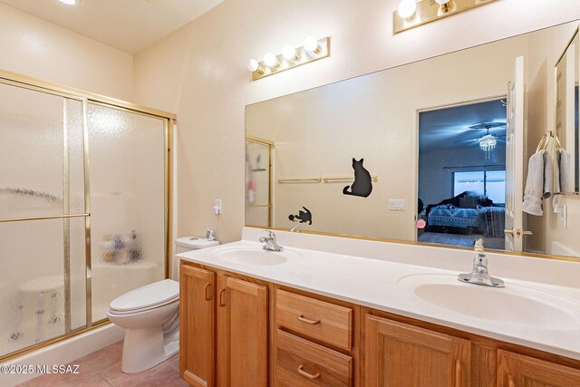 bathroom with a stall shower, a sink, and ensuite bathroom