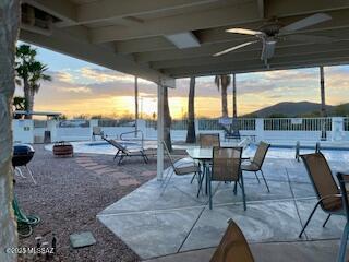 patio terrace at dusk featuring ceiling fan