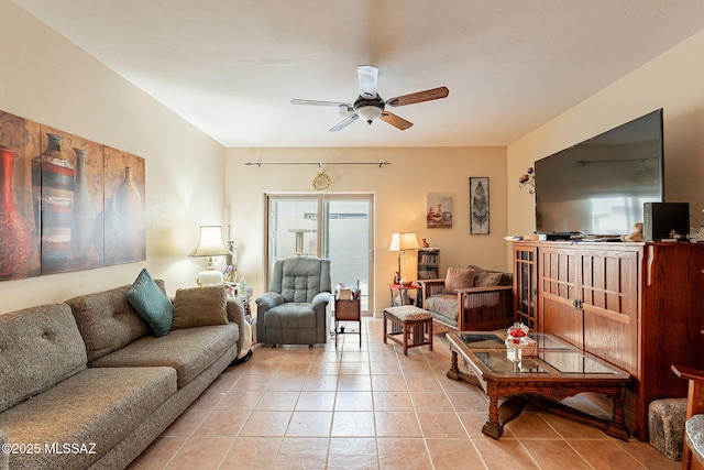 living area with light tile patterned floors and a ceiling fan