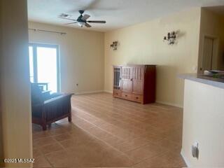 bedroom featuring ceiling fan, baseboards, and tile patterned floors