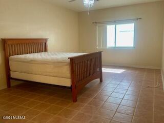 bedroom featuring ceiling fan, visible vents, and light tile patterned flooring