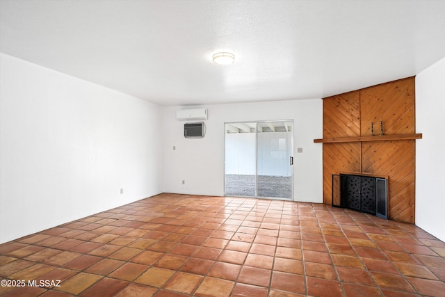 unfurnished living room with tile patterned flooring, a wall mounted AC, and wooden walls