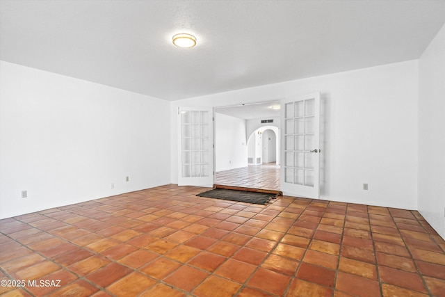 empty room featuring french doors