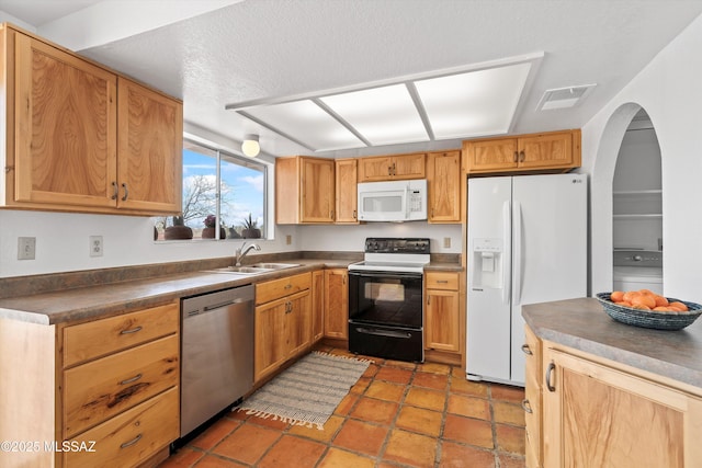 kitchen featuring sink, white appliances, and tile patterned floors