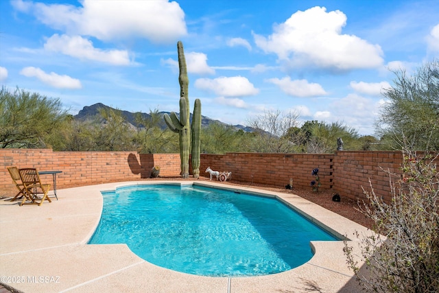 view of swimming pool with a mountain view