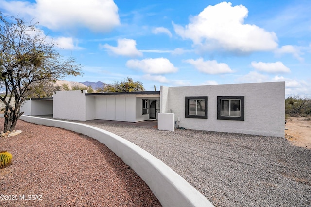 view of front of property with central AC unit and a mountain view