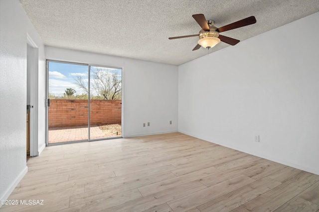 empty room featuring ceiling fan, a textured ceiling, and light wood-type flooring