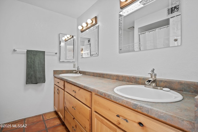 bathroom with a shower with curtain, tile patterned floors, and vanity