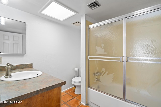 full bathroom featuring enclosed tub / shower combo, vanity, toilet, and tile patterned flooring