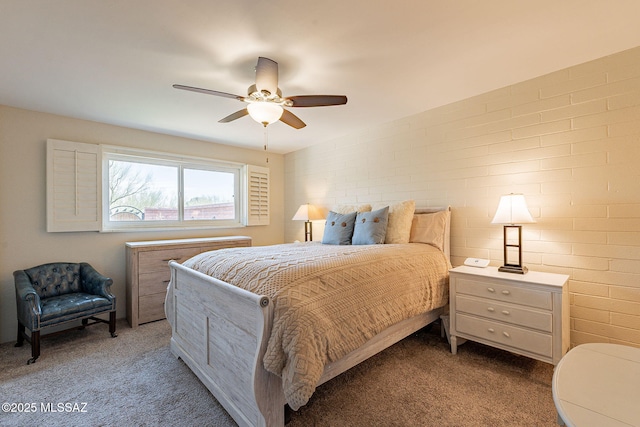 carpeted bedroom featuring brick wall and ceiling fan